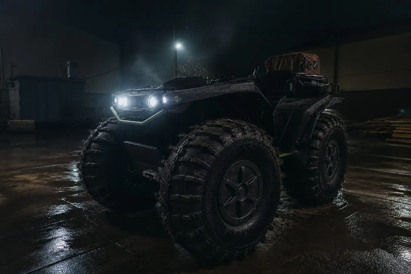 BIG ATV at night with headlights on industrial yard